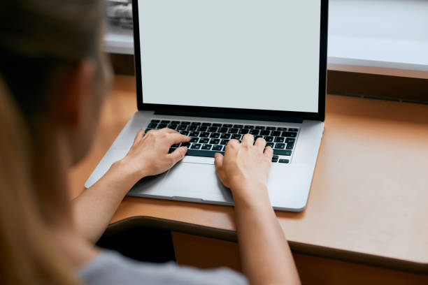 istock Young women working on her laptop with blank copy space screen for your advertising text message in office, Back view of business woman hands busy using laptop at office desk. 1133242363