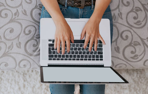 istock Woman working on laptop and writing, top view 1133242368