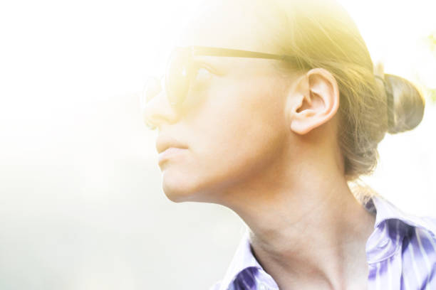istock Young Woman in Sunshine Rays Abstract Background 1133244195