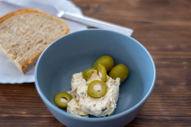 Green olives in a bowl with an olive cream