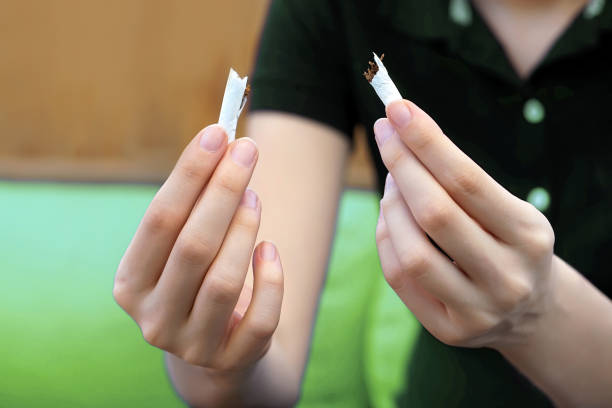 istock A girl breaks a cigarette. Quit smoking. 1133247755