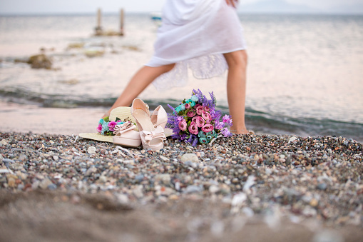 bride walking on beach. Beautiful bride flowers