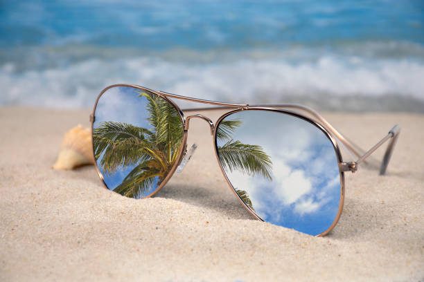 istock mirror sunglasses in tropical beach sand 1133247830