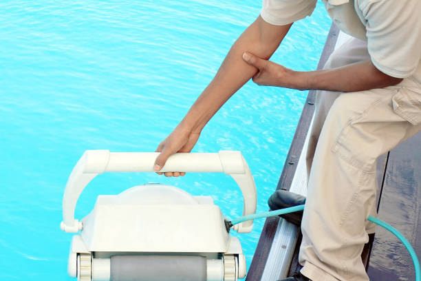 istock Hotel staff worker cleaning the pool. Maintenance. 1133248221