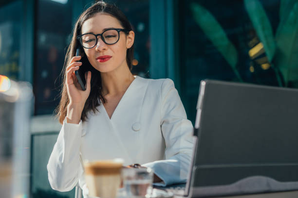istock Elegant young woman is using smart phone 1133248469
