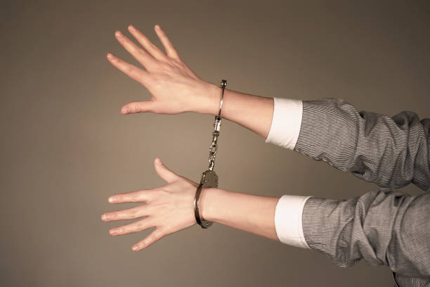 istock Criminal hands locked in handcuffs. 1133249785