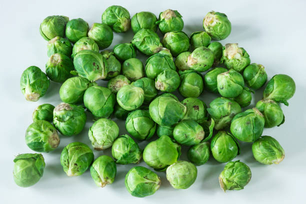 istock heap fresh organic Brussels sprouts, white background 1133250215