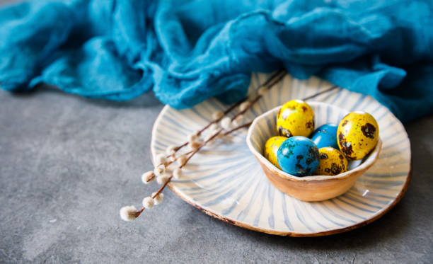 istock Easter Eggs Quail on plates with candles and willows 1133251338