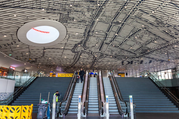 Delft, The Netherlands - February 27, 2019: The newly built train station with commuters passing by in Delft, The Netherlands