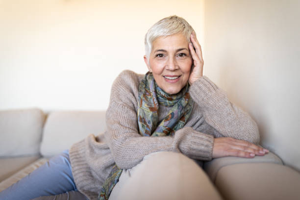 istock Happy senior woman on couch 1133252651