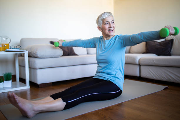 istock Mature woman doing yoga exercise at home 1133252659