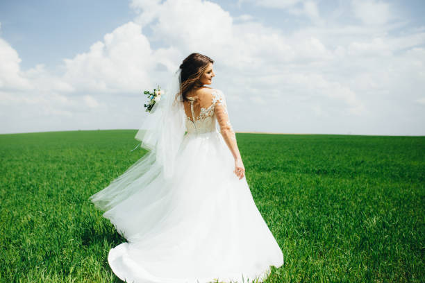 istock Wonderful bride spinning in the field 1133252719