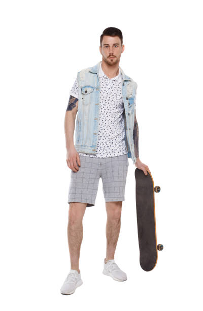 istock A man in shorts with a skateboard. 1133257535