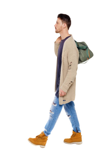 istock back view of walking  man  with green bag. 1133259224