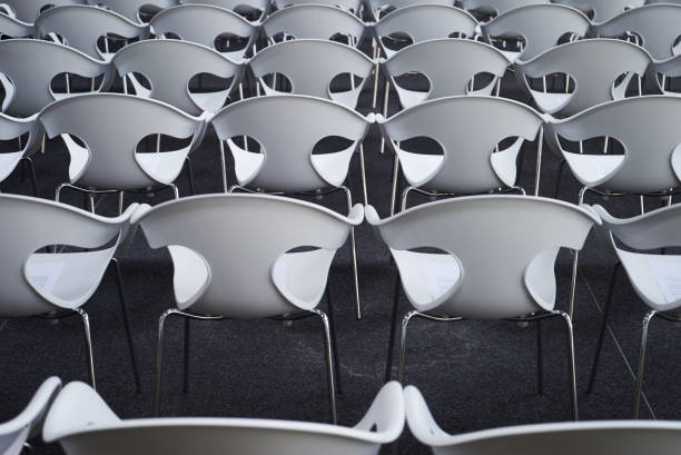 istock Empty auditorium hall with rows of white plastic seats 1133262359