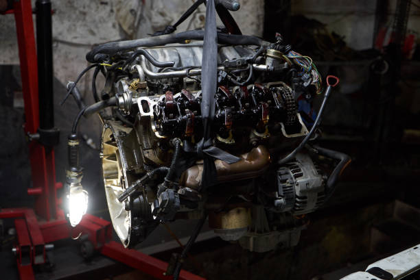 istock Car engine on crane hook in garage repair service, indoor 1133263707