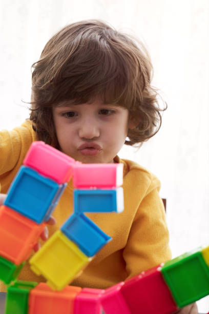 istock Cute boy playing with Preschoolers Building Blocks 1133263838