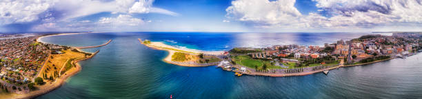 D Newcastle Wide Pan Delta Delta of Hunter river entering Pacific ocean near Newcastle city and port on a sunny summer day in wide aerial panorama of Newcastle waterfront and NObbys head against Stockton beach. newcastle new south wales photos stock pictures, royalty-free photos & images
