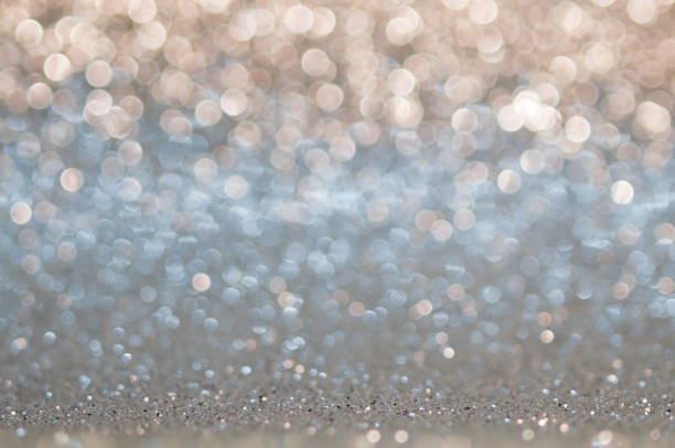 Blue,beige, Silver white ,light brown abstract light background, shining lights, sparkling glittering Christmas lights. Blurred abstract holiday background.