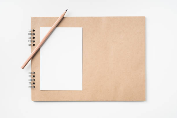 istock kraft notebook, photo frame and pen on white 1133271005