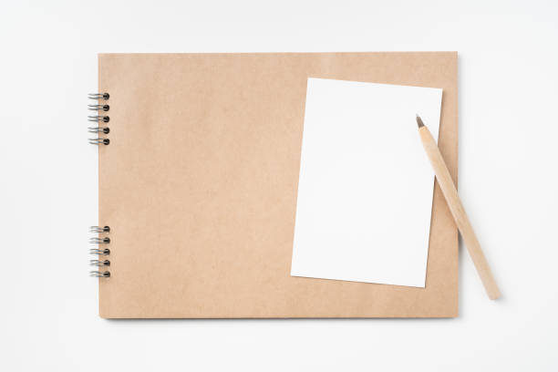 istock kraft notebook, photo frame and pen on white 1133271520