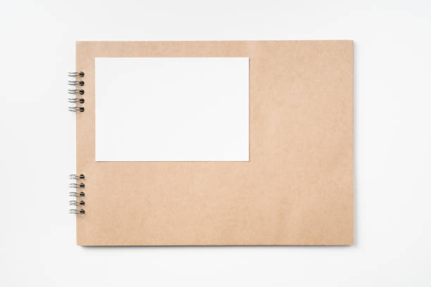 istock kraft notebook, photo frame and pen on white 1133271534
