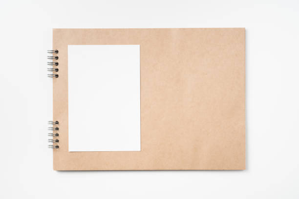 istock kraft notebook, photo frame and pen on white 1133271541