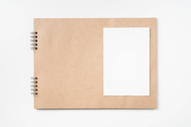 istock kraft notebook, photo frame and pen on white 1133271550