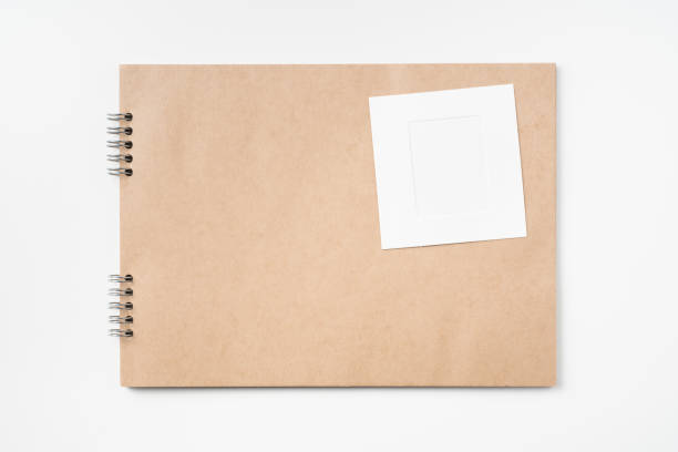 istock kraft notebook, photo frame and pen on white 1133271557