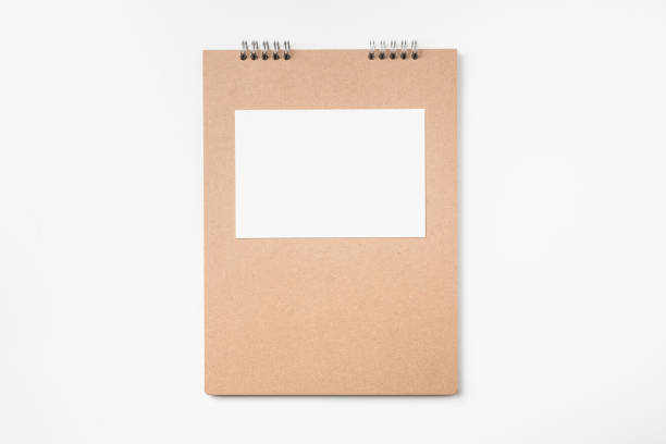 istock kraft notebook, photo frame and pen on white 1133271672