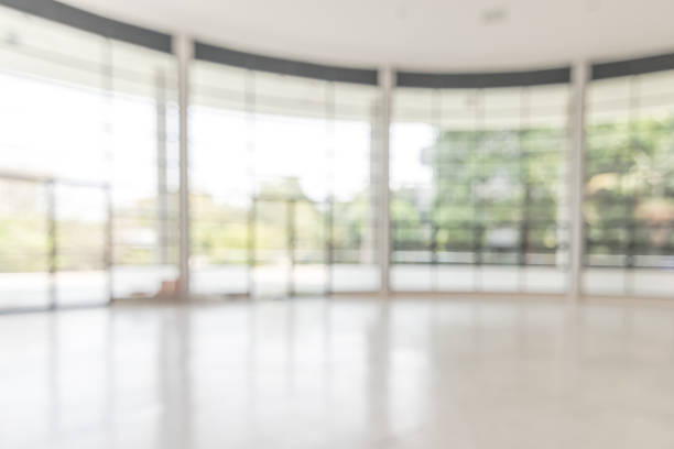 istock Blur background interior view looking out toward to empty office lobby and entrance doors and glass curtain wall 1133275196