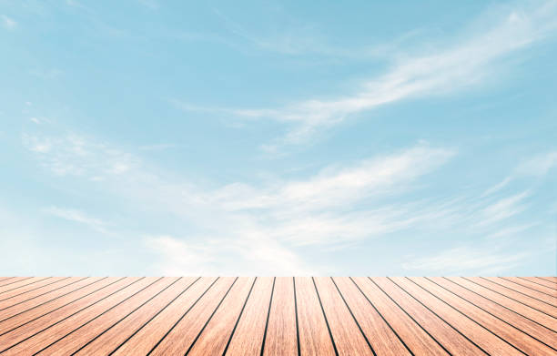 Perspective border wood table beach outside on calm blue sky in spring background concept for wide dinning board on summer landscape wallpaper bacground, mockup promotion product.