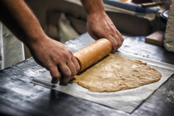 istock Male hands roll out shortbread gingerbread dough. Close-up, top view. For baking Christmas gingerbread or pizza. 1133275849