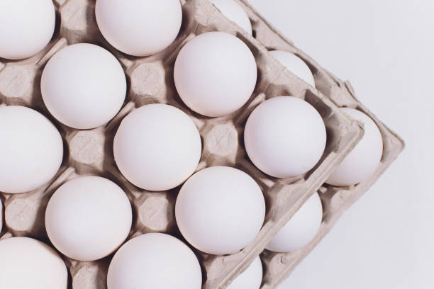 istock White eggs of a hen in harmless, cardboard packing on a white background. 2 packs. 1133275903