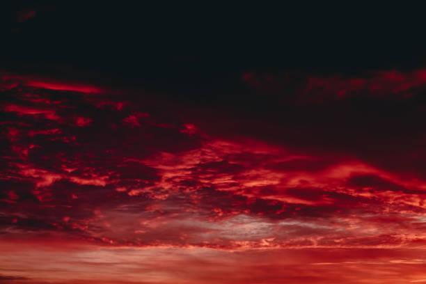 istock Fiery red blood vampire dawn. Amazing warm dramatic fire cloudy sky. Vivid orange sunlight. Atmospheric background of sunrise in overcast weather. Hard cloudiness. Storm clouds warning. Copy space. 1133276130
