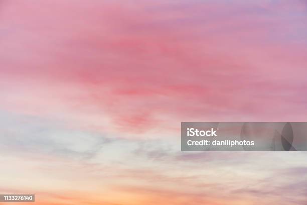 Sunset Sky With Pink Yellow Light Clouds Colorful Smooth Blue Sky Gradient Natural Background Of Sunrise Amazing Heaven At Morning Slightly Cloudy Evening Atmosphere Wonderful Weather On Dawn Stock Photo - Download Image Now