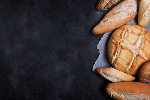 istock Fresh bread on a black chalkboard. Top view with copy space 1133276578