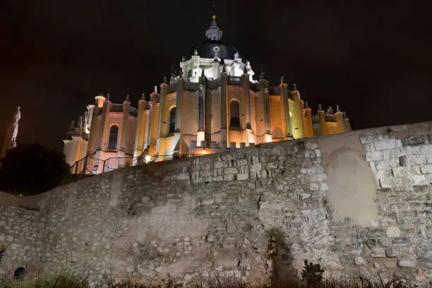 Remains of the Muslim Walls of Madrid (Old City Wall) and Almudena Cathedral in Madrid, Spain. Image taken from Emir Mohamed Park.
