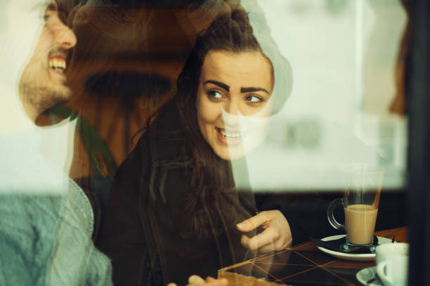 istock Young couple talking and laughing in a cafe 1133286348