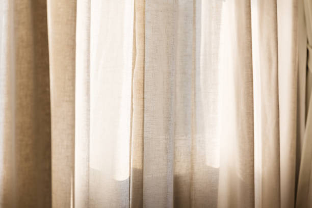 istock morning sunlight through curtain in room 1133286388