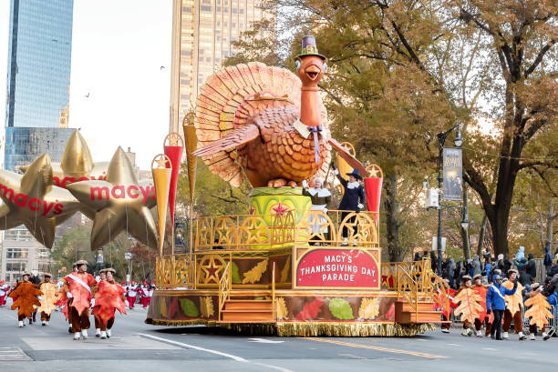 The 92th annual Macy's Thanksgiving Day Parade New York City, NY, USA - November 22, 2018:  Turkey float in NYC with pilgrim marchers and spectators near the start of The 92th annual Macy's Thanksgiving Day Parade festival float stock pictures, royalty-free photos & images