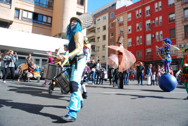 madrid, spain, march 2nd 2019: carnival parade, members of tabarilea percusion playing and dancing - traditional festival juggling women performer imagens e fotografias de stock