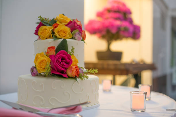 istock Beautiful white wedding cake with real flowers surrounded by candles 1133300909