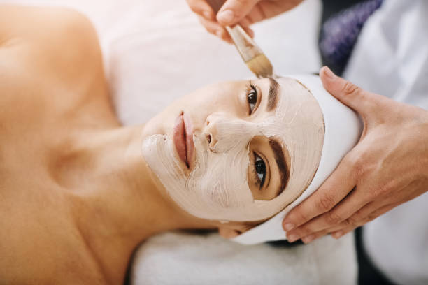 Nourished skin is happy skin Shot of an attractive young woman getting a facial at a beauty spa facial chemical peel stock pictures, royalty-free photos & images