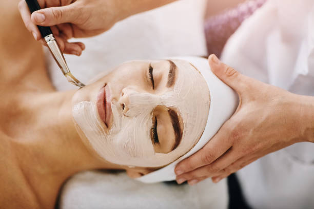 I can already feel it tingling Shot of an attractive young woman getting a facial at a beauty spa facial chemical peel stock pictures, royalty-free photos & images