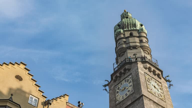 timelapse of clock tower in famous in old town Innsbruck Austria with cloud sky