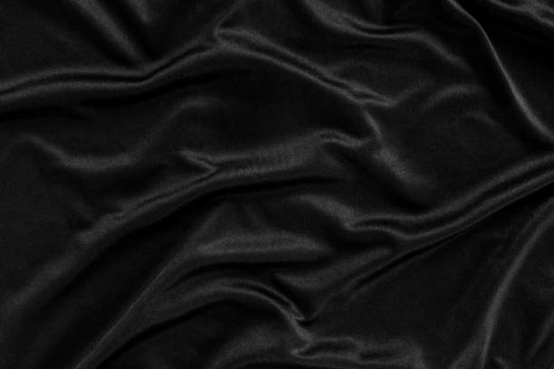 istock Abstract background. luxury cloth or liquid wave or wavy folds.Black satin fabric texture wallpaper. 1133307887