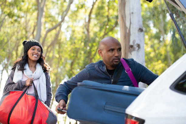 istock Couple loading luggage into car trunk for outdoors vacation. 1133315599