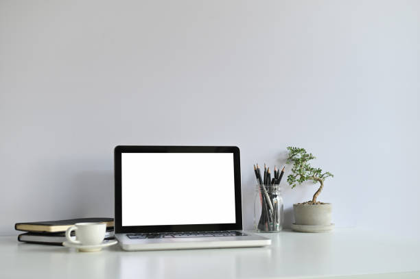 istock Mockup laptop computer and office supplies and small bonsai on workspace. 1133316452