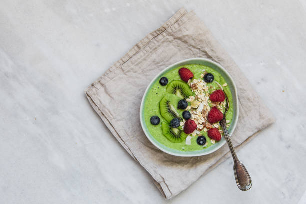 istock Smoothie breakfast bowls with berries, seeds, oats and nuts on white background with copy space 1133317964